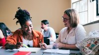 Two teachers meet in classroom
