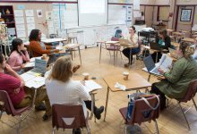 Group of teachers meet in a classroom