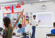 Teacher leading classroom via projector screen