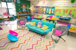 A classroom filled with colorful couches and lightweight chairs.