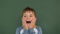 An elementary school student acts surprised