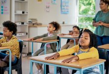 Photo of elementary school students meditating in class
