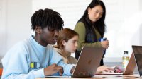 Photo of middle school students on laptops in classroom