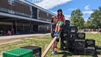 Kids playing with slide made from milk crates