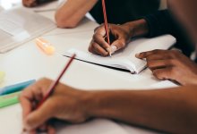 Students taking creative notes with different writing instruments